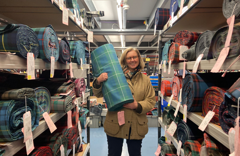 Picture of Rachael Hamilton MSP holding her family tartan, woven by Lochcarron, attached.